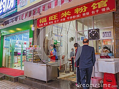 Unacquainted People and Restaurant Owner in Chinese Breakfast Restaurant at Zhangjiajie City China Editorial Stock Photo