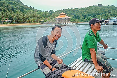 Unacquainted Thai Tour Guide on Koh Chang smiling Very Happy on The Boat in Vacation time.People very Enjoy His work Editorial Stock Photo