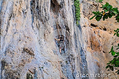 Unacquainted Tourist Climbing on the cliff in Phra nang Cave Beach krabi city Thailand. Editorial Stock Photo