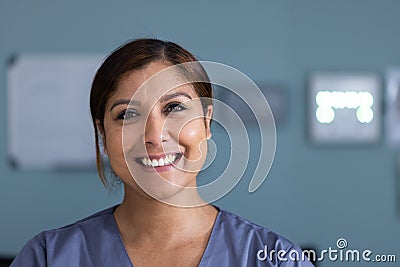 Unaltered portrait of happy asian female doctor smiling in hospital corridor, copy space Stock Photo