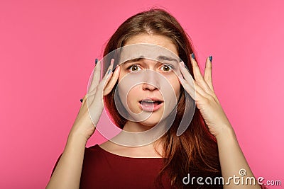 Unbelievable shocked surprised woman clutch head Stock Photo