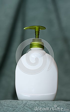 Unbranded bottle with batcher on towel background Stock Photo