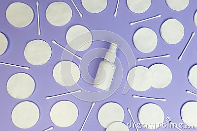 Unbranded white plastic spray bottle mockup and cotton pads pattern on purple background. Top view, flatlay, lifestyle. Clean Stock Photo