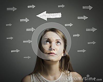 Uncertain. Girl in white and arrows. Stock Photo