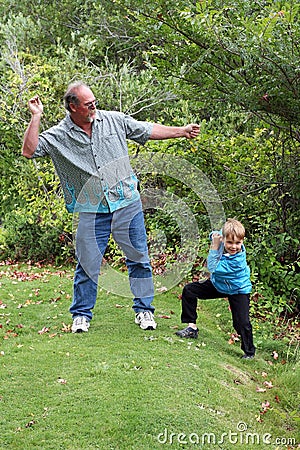 Uncle teaches boy to skip stones Stock Photo