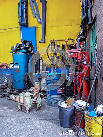 Unclean and messy corner inside an auto repair workshop Stock Photo