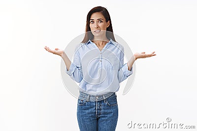 Uncomfortable awkward adult female coworker shrugging, clench teeth sorry expression, apologizing unaware not know Stock Photo