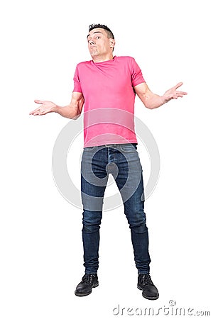 Uncomprehending man spreading hands and shrugging shoulders Stock Photo