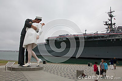 Unconditional Surrender statue with USS Midway Editorial Stock Photo