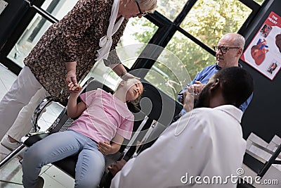 Unconscious child having chest pain suffering from heart attack in hospital reception Stock Photo