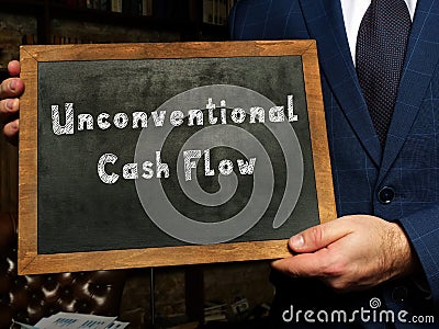 Unconventional Cash Flow inscription on the black chalkboard Stock Photo