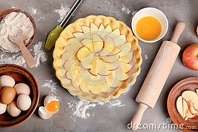Uncooked apple pie with ingredients on table Stock Photo