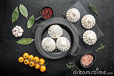 Uncooked Baozi chinese dumplings. Azian dumplings, on black stone background, top view flat lay Stock Photo