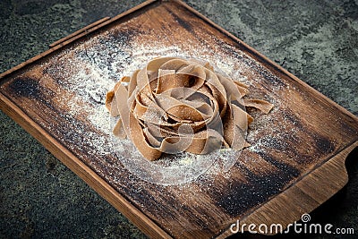 Uncooked brown pasta tagliatelle with chestnuts Stock Photo
