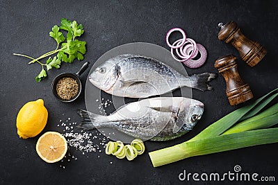 Uncooked dorado fish, spices and vegetables Stock Photo