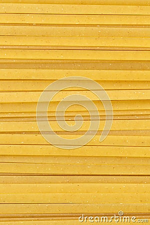 Uncooked durum fettuccine pasta background. Close up of raw spaghetti. Full frame of noodles Stock Photo