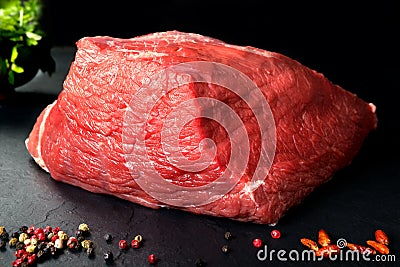 Uncooked fresh pork and beef. Raw red meat with black stone background and spices Stock Photo