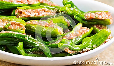 Uncooked Fresh Stuffed Green Peppers ready for cooking Stock Photo