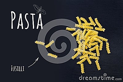 Uncooked Italian pasta Fusilli on black slate stone background Stock Photo
