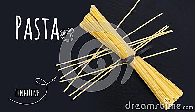 Uncooked Italian pasta Linguine on black slate stone background Stock Photo