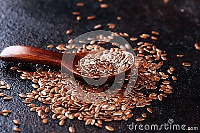 Uncooked linseed in wooden spoon, rustic style. Healthy linseed Stock Photo