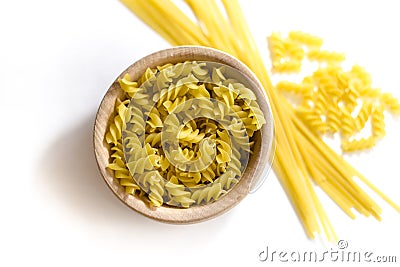 Uncooked pasta in a wooden bowl. Stock Photo