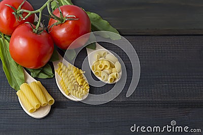 Uncooked pasta in a wooden spoo Stock Photo