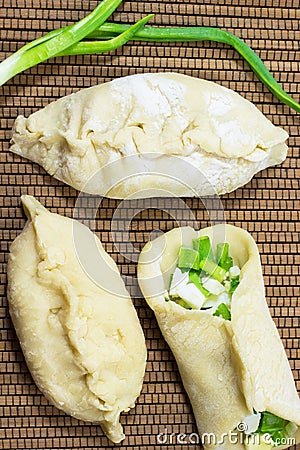 Uncooked pies. Filling - green onions and eggs Stock Photo