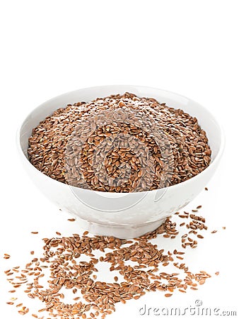 Uncooked, raw linseed or flax seed in white bowl over white back Stock Photo