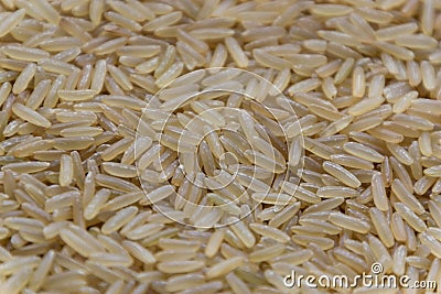 Uncooked raw long brown rice grains background, top view Stock Photo