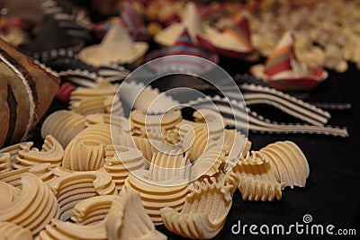 Uncooked Ruled and Curved Italian Pasta on Black Table Stock Photo