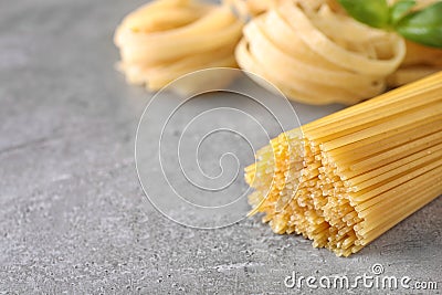Uncooked spaghetti on grey table. Italian pasta Stock Photo
