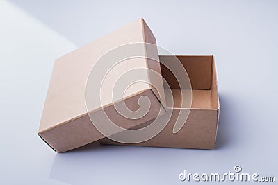 Uncovered small cardboard box. Stock Photo