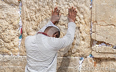 Undefined afro-american young man pray at the Western Wall. Jerusalem Editorial Stock Photo