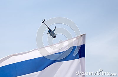 Undefined helicopter with passengers in blue sky Stock Photo