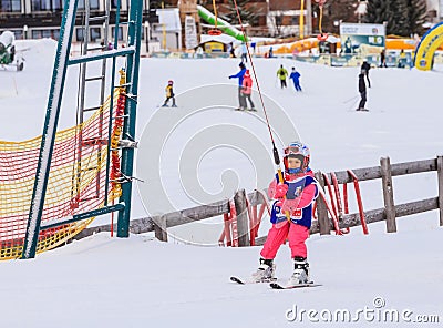 An undefined little skier in the ski lift Editorial Stock Photo