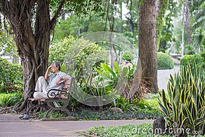 Ho Chi Minh City, Vietnam - September 1, 2018: an undefined man sitting at a corner of the park thinking about something. Editorial Stock Photo