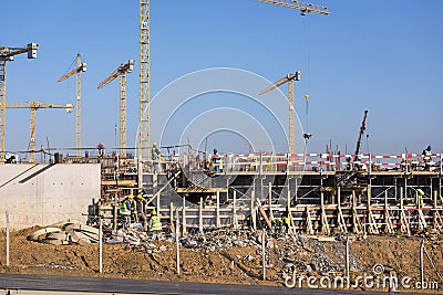 Undefined workers working on construction Editorial Stock Photo