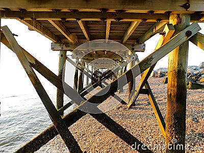 Under The Pier At The Beach Stock Photo