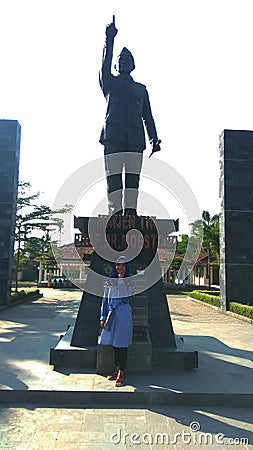 under the scorching heat of the sun, a photo together with a statue of an Indonesian heroMajor General of TNI prof.Dr.Moestopo Editorial Stock Photo