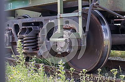 The undercarriage of the carriage with wheels and springs. Passenger train, freight train. Industrial railway wheels close up Stock Photo