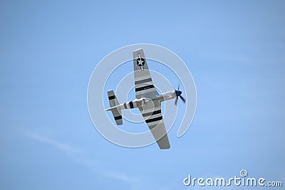 Undercarriage view of a North American P-51 Mustang WWII aircraft flying at Springbank Airport Editorial Stock Photo