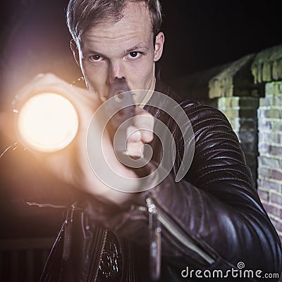 Undercover law enforcement special agent aiming gun and torch Stock Photo