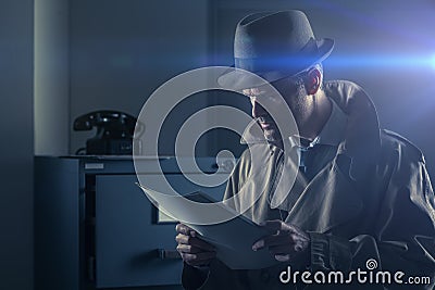 Undercover spy stealing files Stock Photo