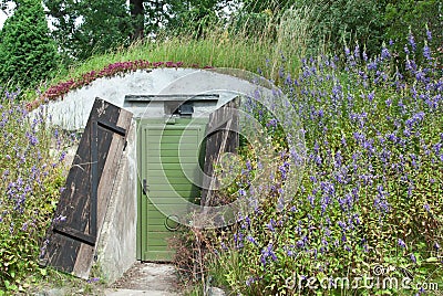 Underground dwelling under a blooming hill Stock Photo