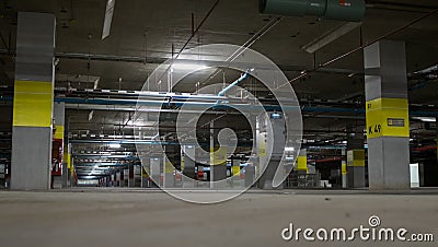 Underground parking with neon light ,fire extinguisher and pipe, Bangkok Thailand Editorial Stock Photo