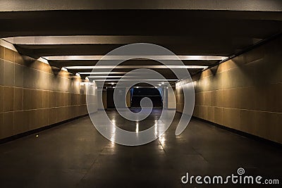 Underground passage illuminated by night light lamps Stock Photo