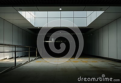 Underground road tunnel with fenced pedestrian stairway alongside Stock Photo