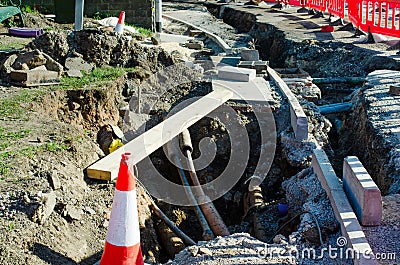 Underground services exposed during roadworks and construction of the new pedestrian footpath and road crossing Stock Photo