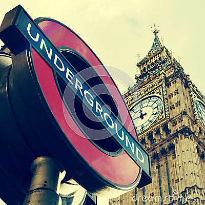 Underground sign and the Big Ben in London, United Kingdom, with Editorial Stock Photo